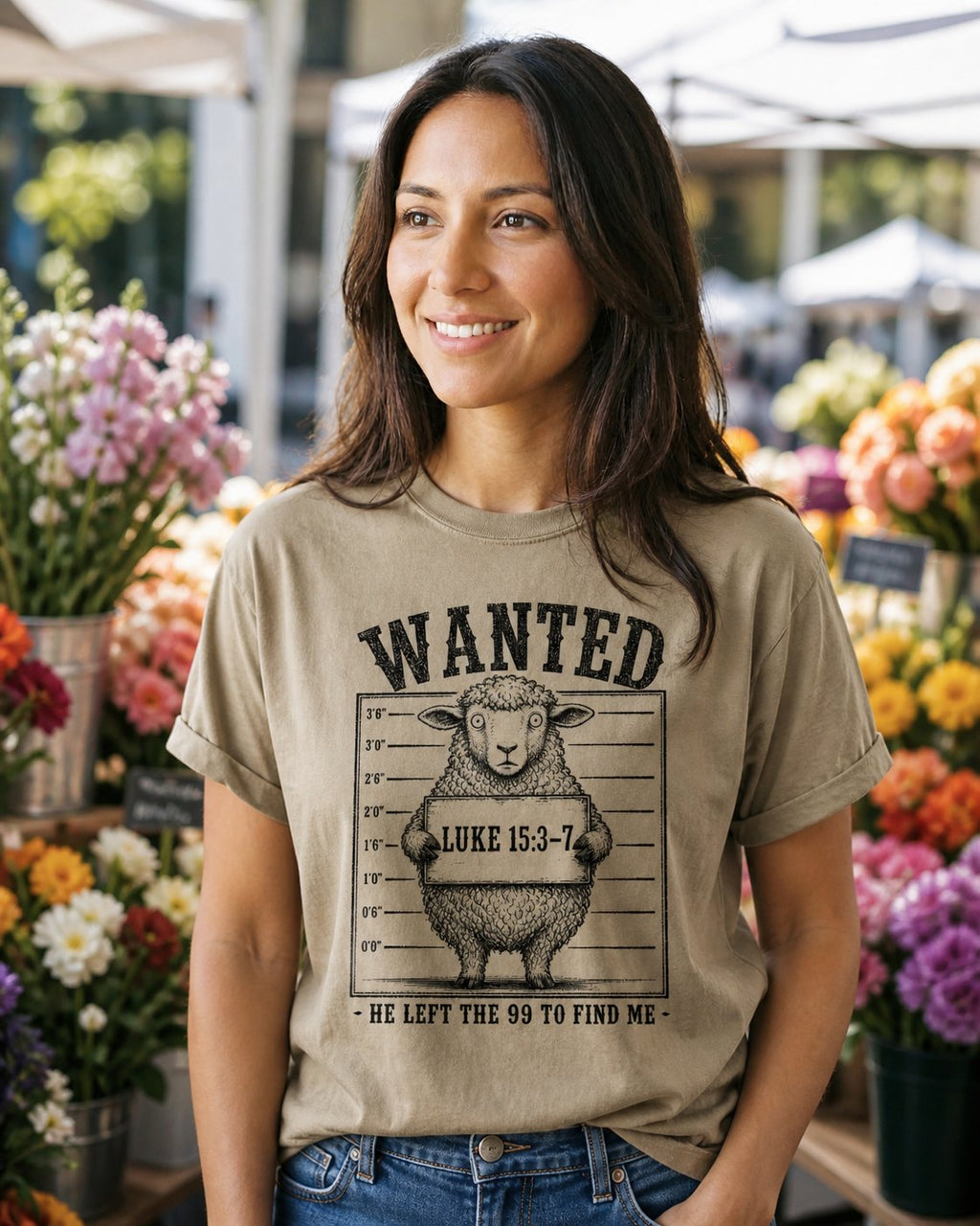 He Left the 99 to Find me – Khaki women's Christian tee, lifestyle photo in farmers market – Western wanted poster with a sheep in a mugshot lineup – Luke 15:3-7 – She Wears Faith