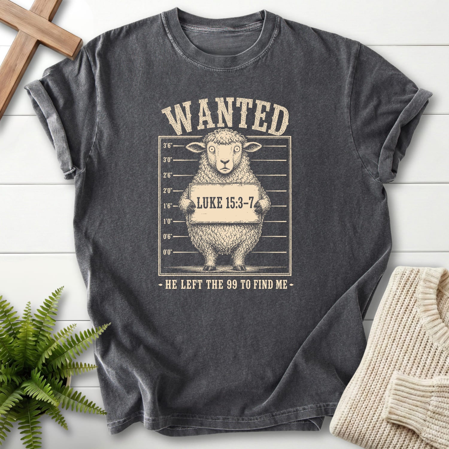 Flat lay of a Pepper Comfort Colors 1717 women's Christian tee featuring "He Left the 99 to Find me Dark T-Shirt" Luke 15:3-7.