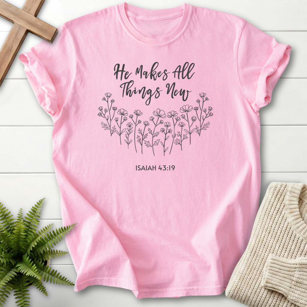 Blossom women's faith t-shirt with script lettering for 'He Makes All Things New' and a delicate wildflower border, inspired by Isaiah 43:19.