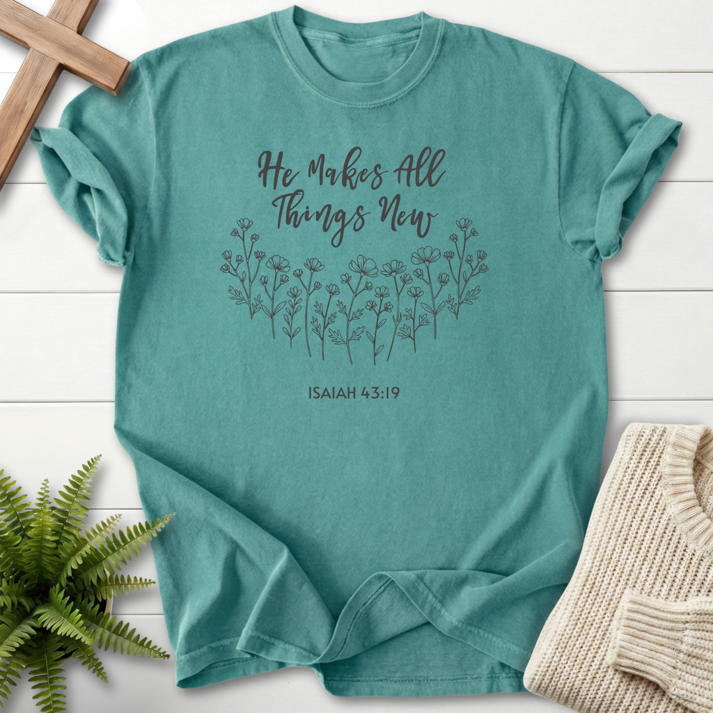 Chalky Mint Bible verse tee with a hand-drawn wildflower row and 'He Makes All Things New', inspired by Isaiah 43:19.