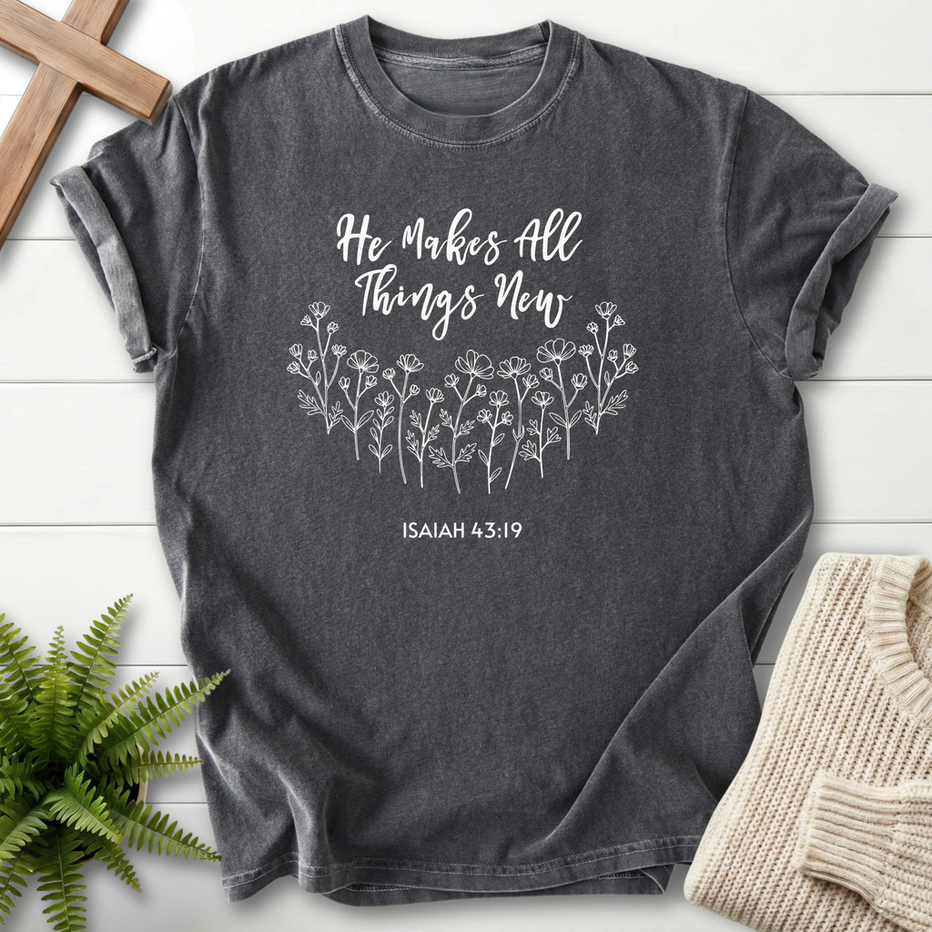 Pepper women's faith t-shirt with 'He Makes All Things New' script and a wildflower illustration, inspired by Isaiah 43:19.