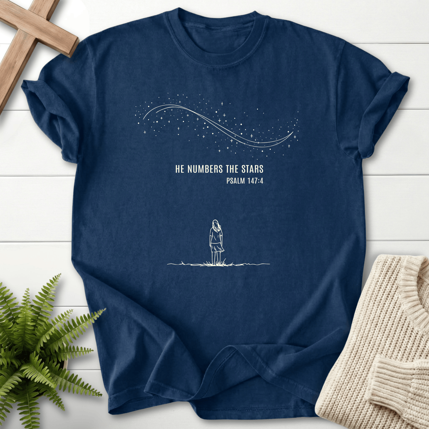 Navy women's Christian t-shirt with a minimalist woman beneath the stars, inspired by Psalm 147:4