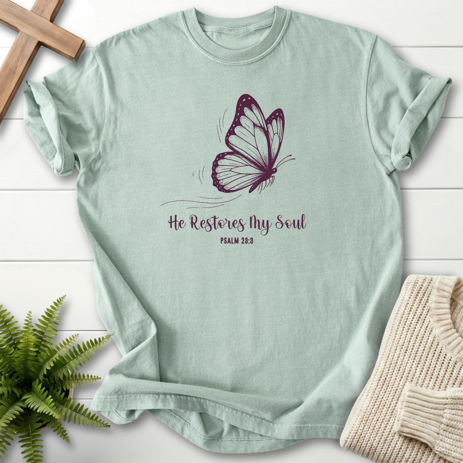 Bay women's Christian t-shirt with detailed butterfly art and "He Restores My Soul" script, inspired by Psalm 23:3