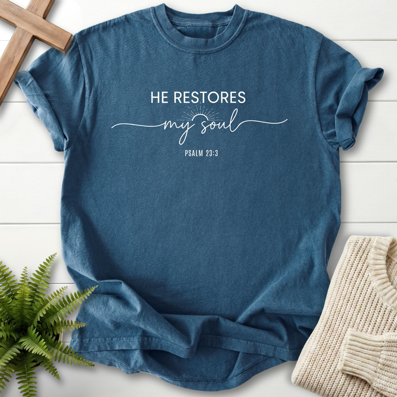 Midnight women's Christian t-shirt with sunburst detail and mixed "He Restores My Soul" lettering, inspired by Psalm 23:3