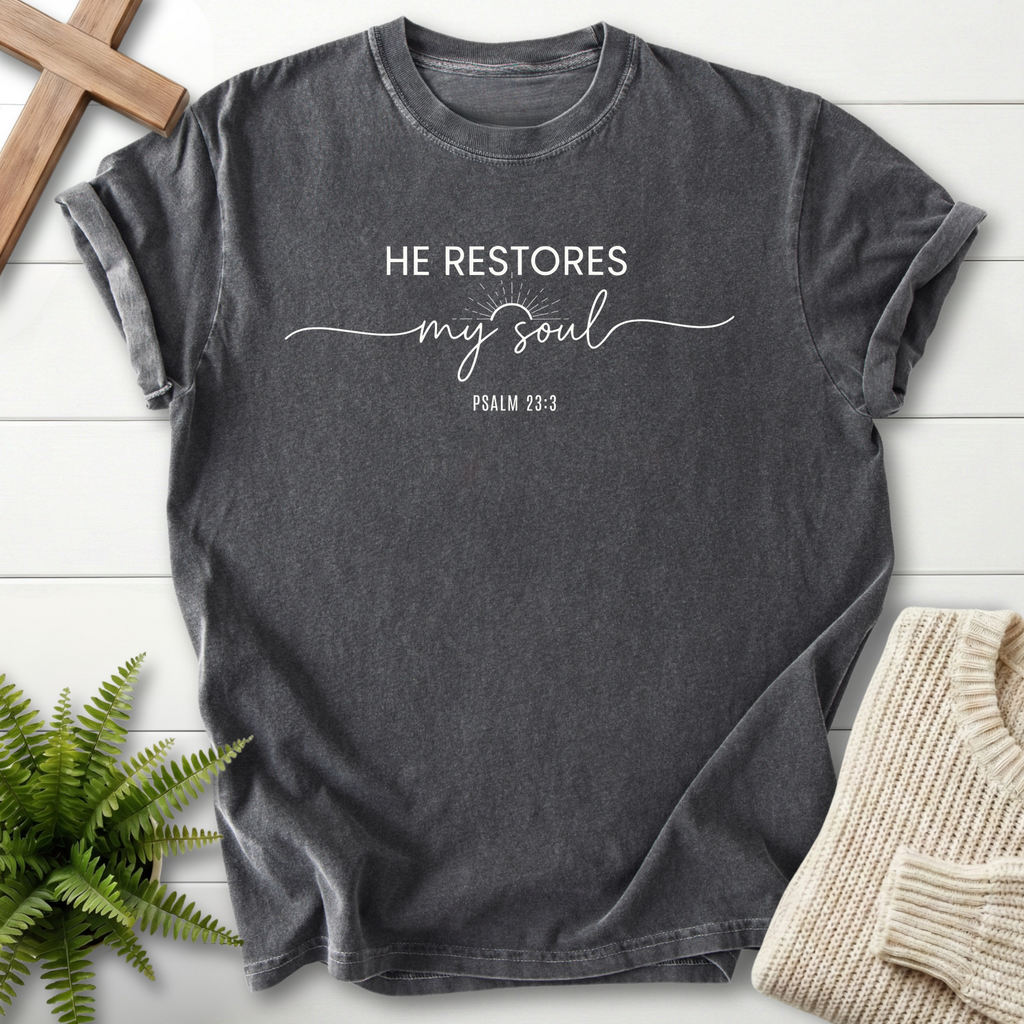Pepper women's Christian t-shirt with bold block and cursive "He Restores My Soul" lettering and a small sunburst, inspired by Psalm 23:3