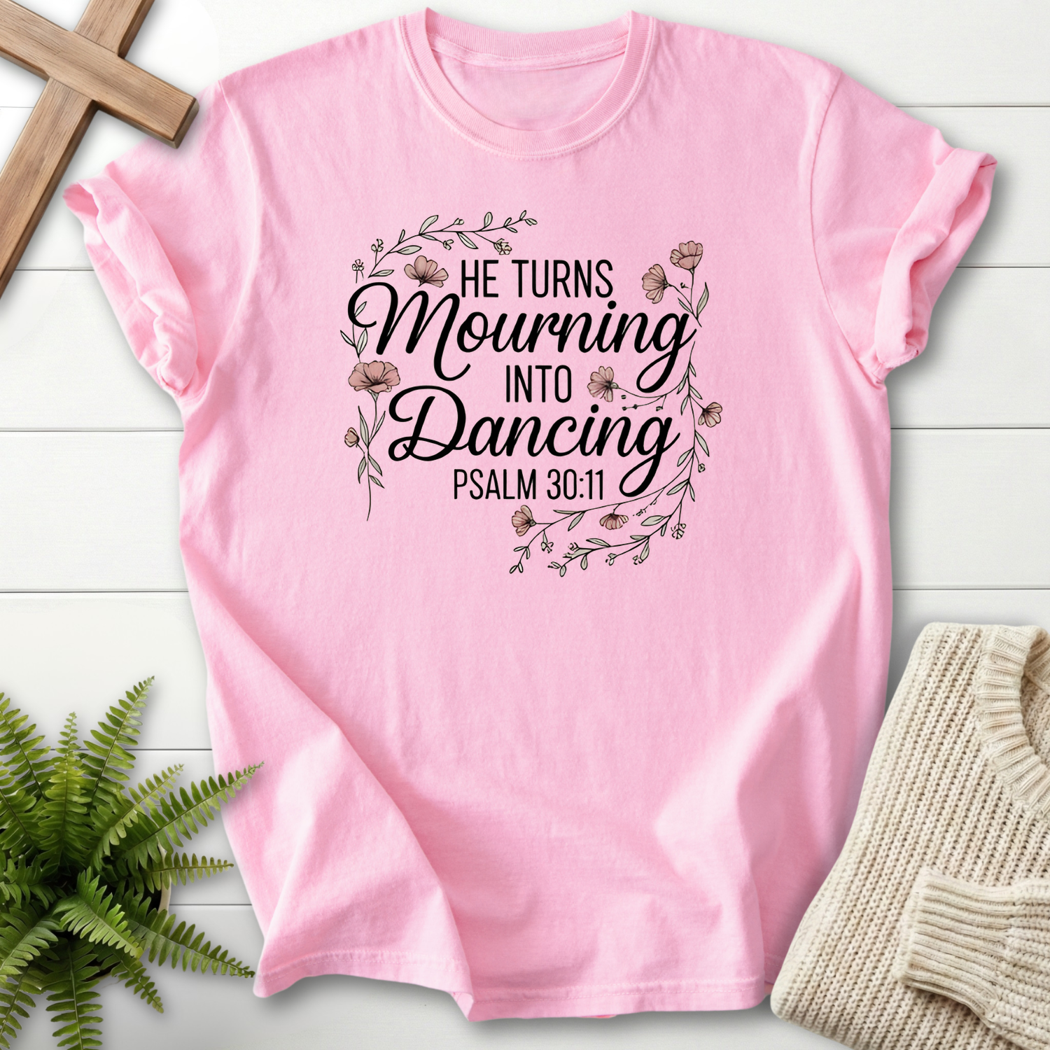 Blossom women's Christian t-shirt with a floral wreath around "He Turns Mourning Into Dancing," inspired by Psalm 30:11