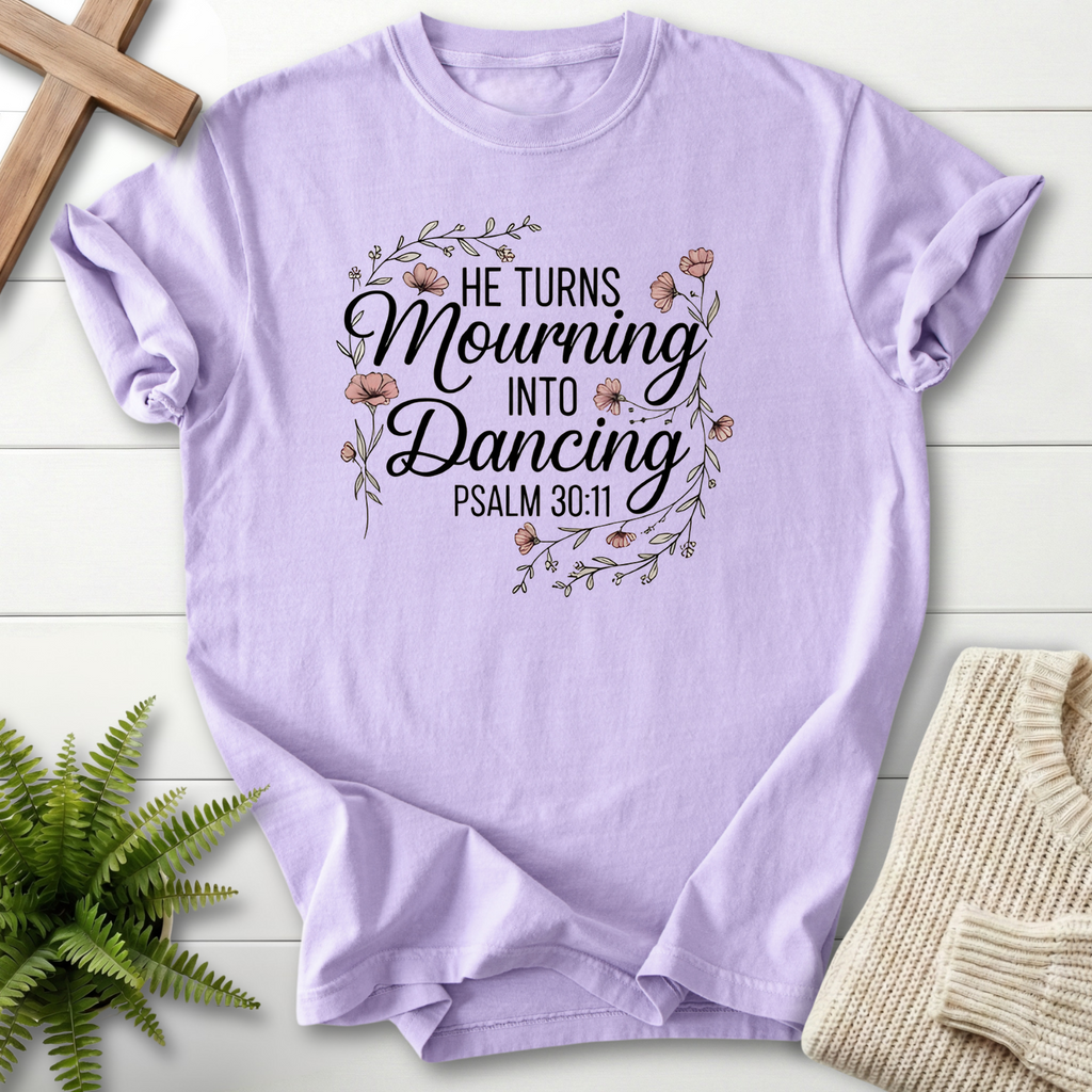 Orchid women's Christian t-shirt with floral wreath artwork and "He Turns Mourning Into Dancing," inspired by Psalm 30:11