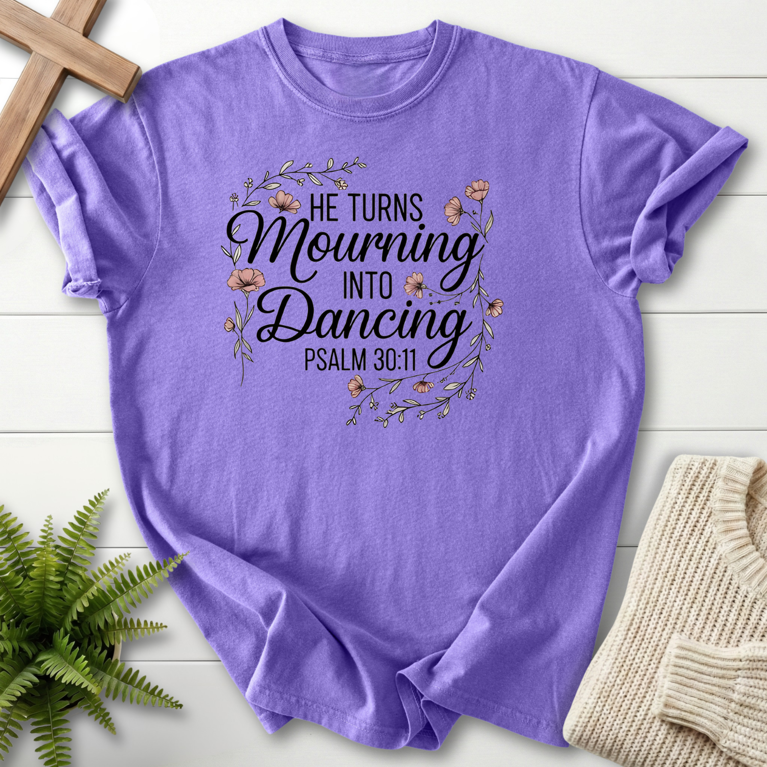 Violet women's Christian t-shirt with a decorative floral border and "He Turns Mourning Into Dancing," inspired by Psalm 30:11