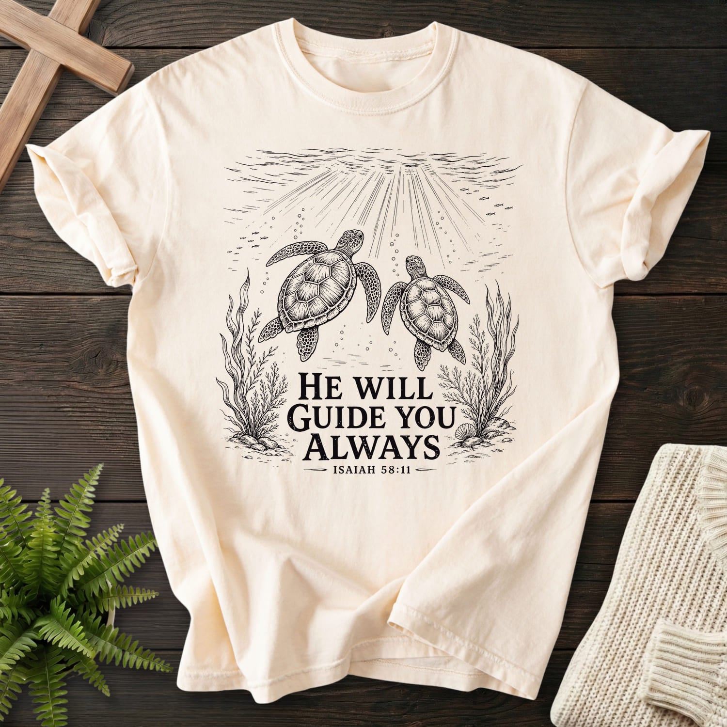 Flatlay of an Ivory faith-based tee with vine and grape artwork with "He Will Guide You Always Isaiah 58:11 T-Shirt" Isaiah 58:11.