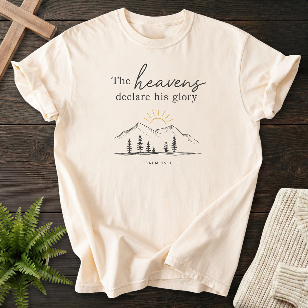 Ivory color option for the Heavens Declare His Glory Christian t-shirt for women with sunrise graphic with "Heavens Declare His Glory Dark T-Shirt" P.
