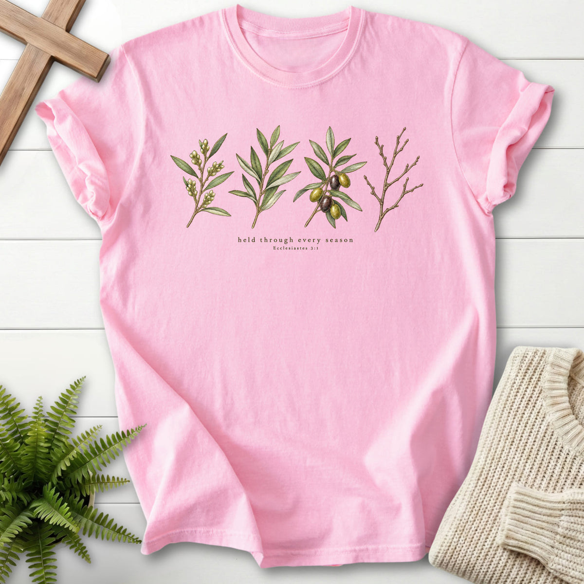 Flatlay of a Blossom Comfort Colors 1717 Christian graphic tee with flower artwork with "Held Through Every Season T-Shirt" Ecclesiastes 3:1.