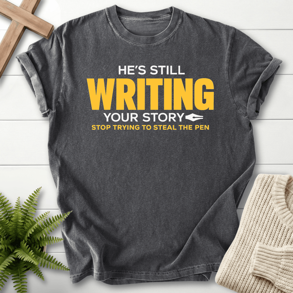 He's Still Writing Your Story T-Shirt in Pepper | She Wears Faith
