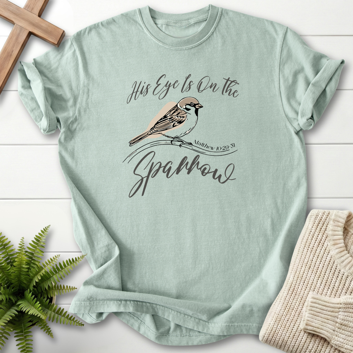 Bay women's Christian t-shirt with a sparrow on a branch and "His Eye Is on the Sparrow," inspired by Matthew 10:29-31