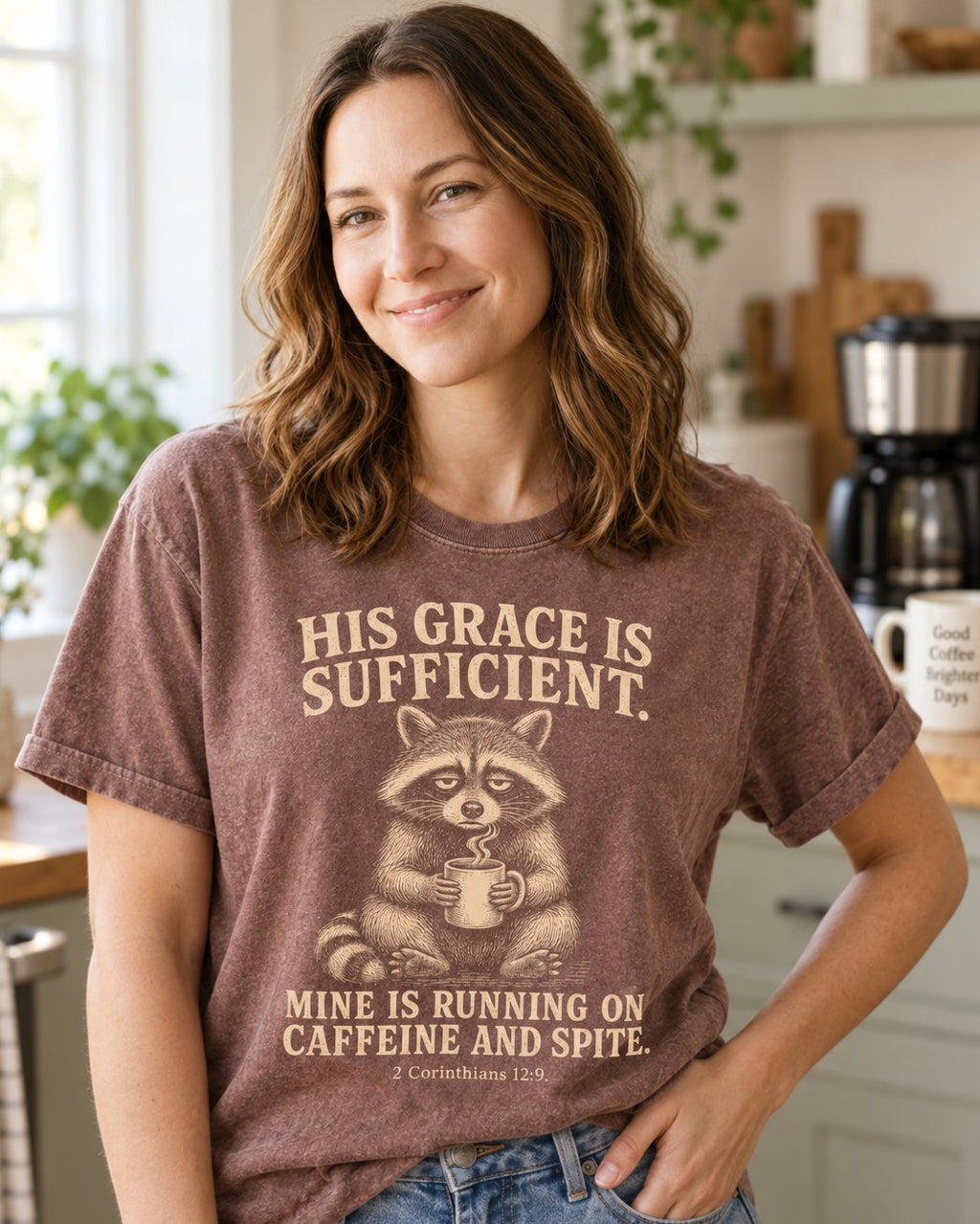 His Grace Is Sufficient Raccoon – Espresso women's Christian tee, lifestyle photo in morning kitchen setting – Tired raccoon holding a coffee mug with funny caffeine text – 2 Corinthians 12:9 – She Wears Faith