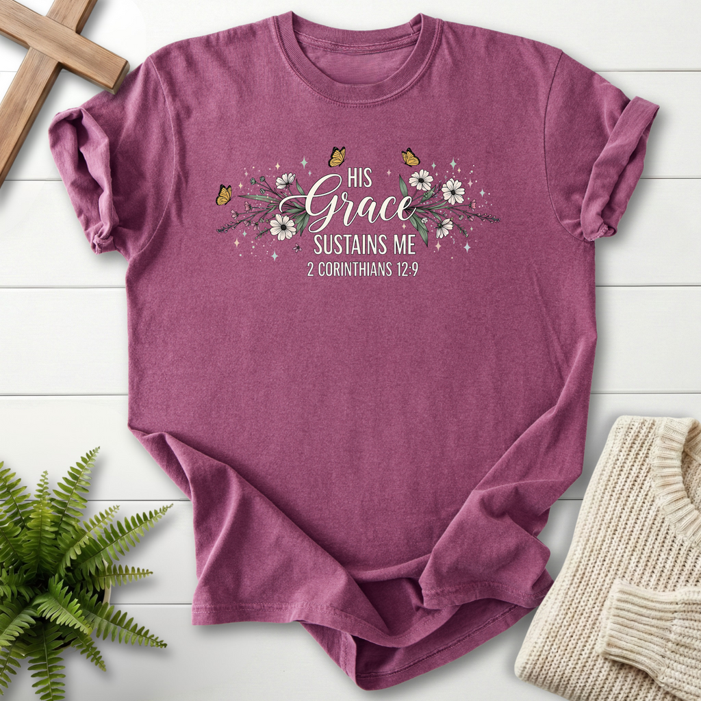 Berry women's Christian t-shirt with a floral garland and butterfly illustration around "His Grace Sustains Me"