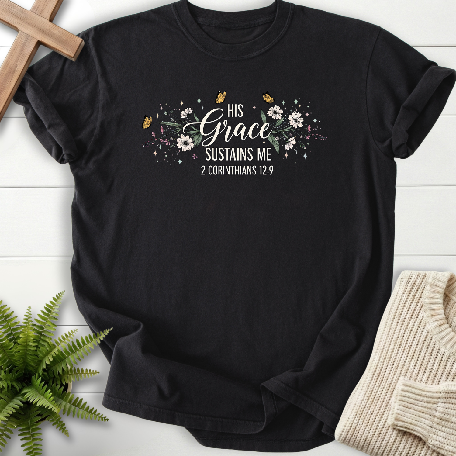 Black women's Christian t-shirt with botanical flowers, butterflies, and "His Grace Sustains Me," inspired by 2 Corinthians 12:9