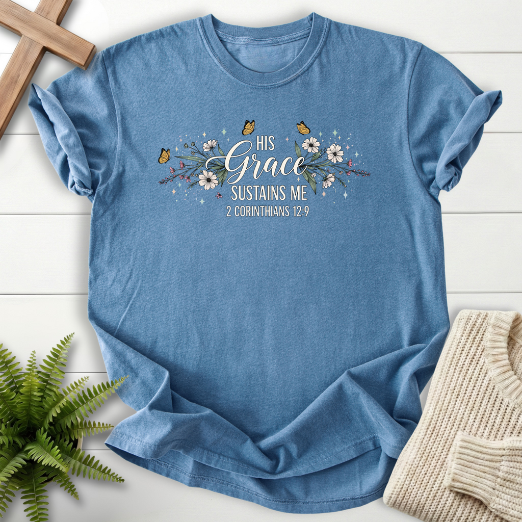 Blue Jean women's Christian t-shirt with a floral butterfly border and "His Grace Sustains Me" lettering, inspired by 2 Corinthians 12:9