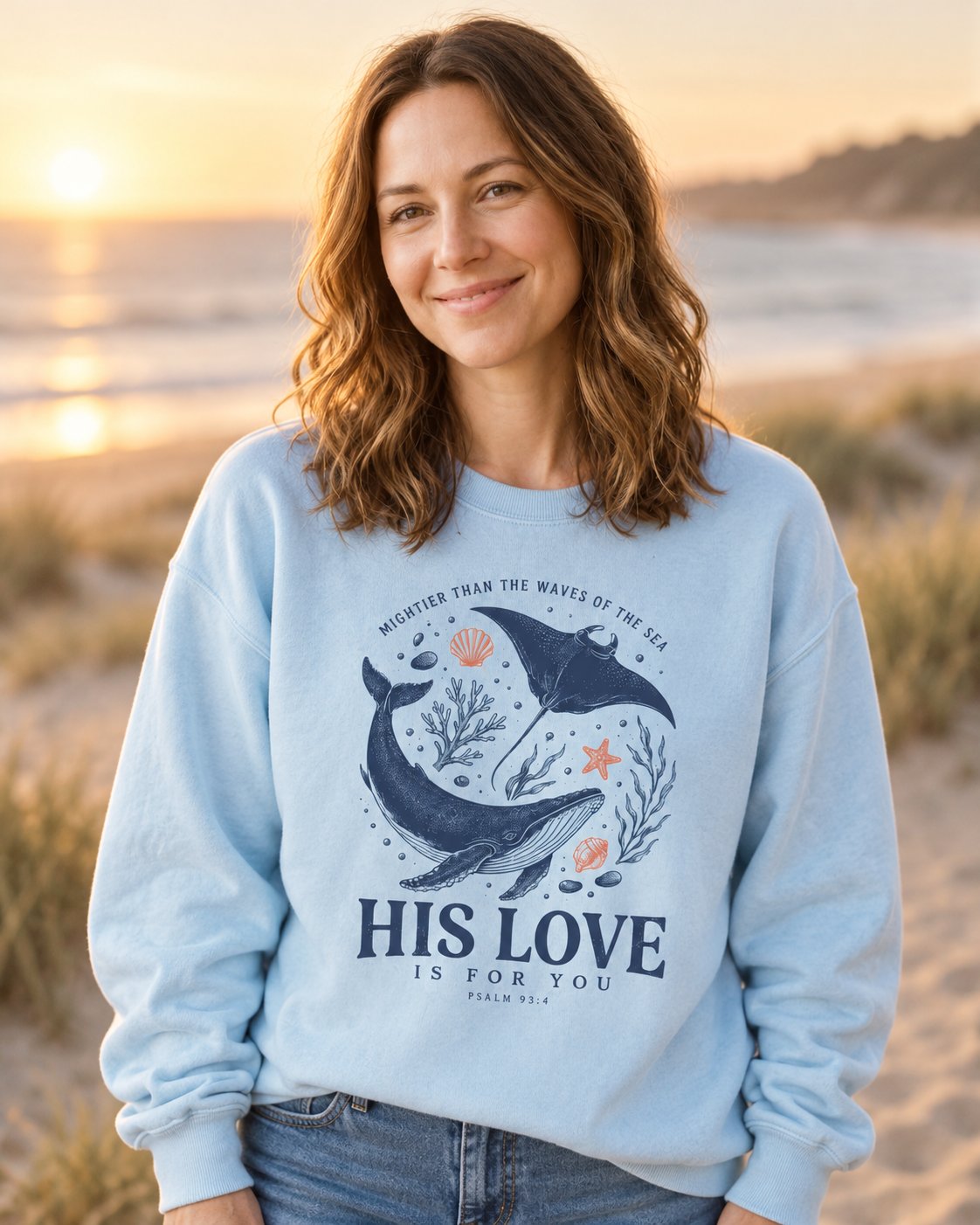 His Love Is For You Psalm 93:4 – Chambray women's Christian sweatshirt, lifestyle photo in seaside setting – Whale and manta ray above HIS LOVE IS FOR YOU – She Wears Faith