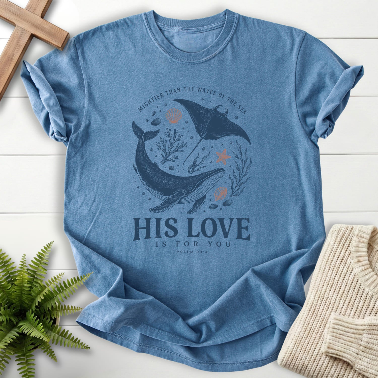 Flatlay of a Blue Jean Bible verse tee with minimal whale artwork with "His Love Is For You Psalm 93 4 T-Shirt" Psalm 93:4.