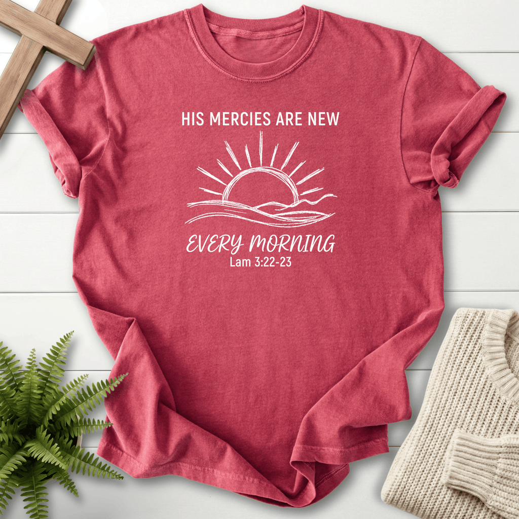 Crimson women's Christian t-shirt with a sunrise over rolling hills and "His Mercies Are New Every Morning," inspired by Lamentations 3:22-23.