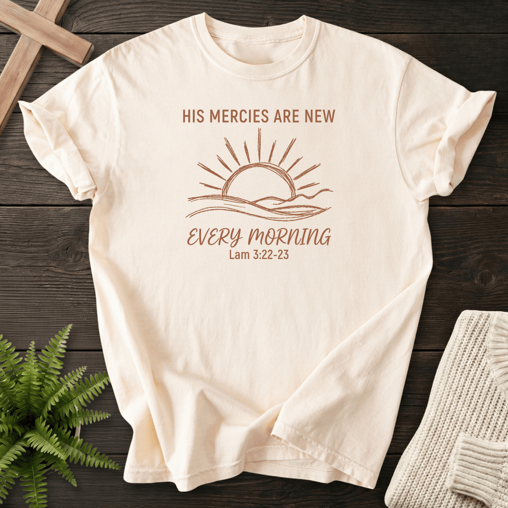 Ivory women's Christian t-shirt with minimalist sunrise line art and "His Mercies Are New Every Morning," inspired by Lamentations 3:22-23.