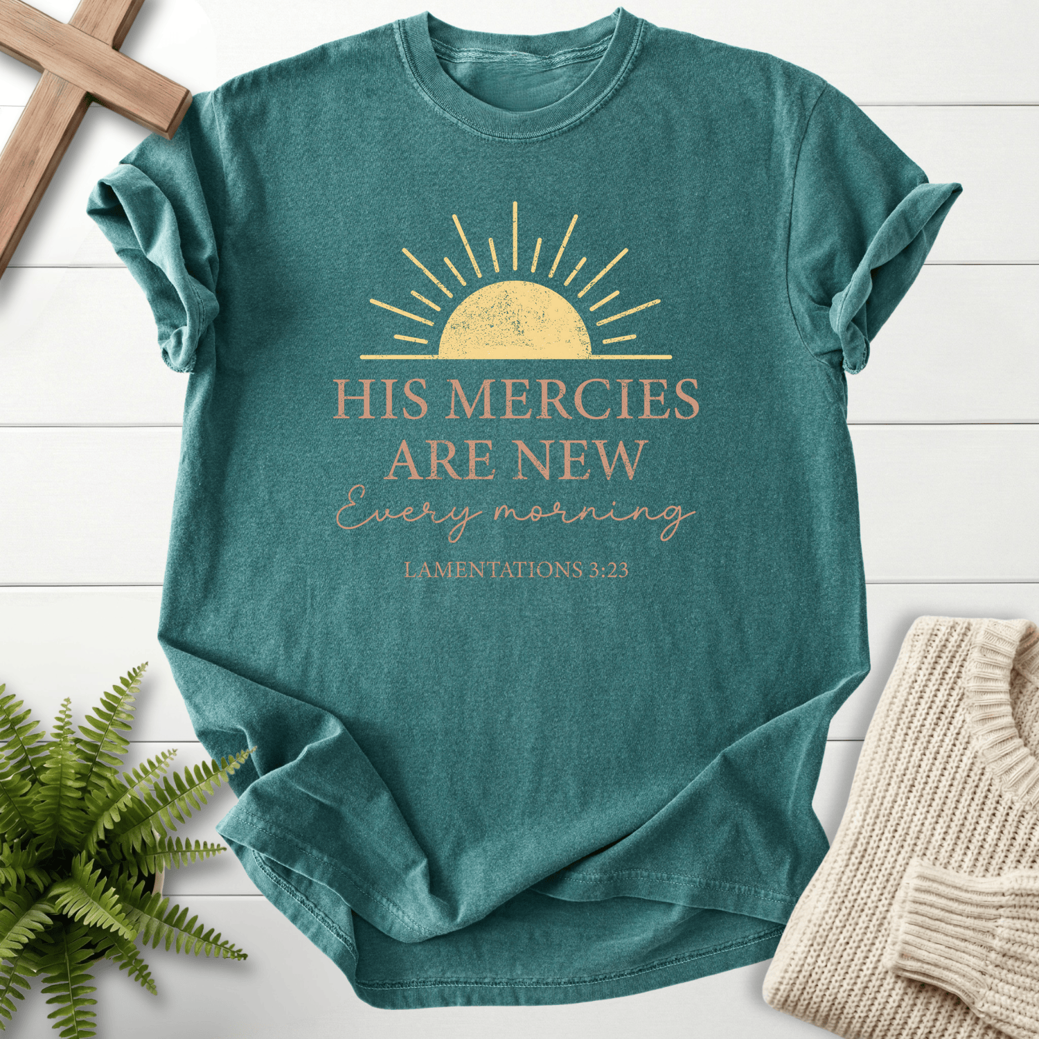 Blue Spruce women's Scripture shirt with a golden sunrise illustration, inspired by Lamentations 3:23.