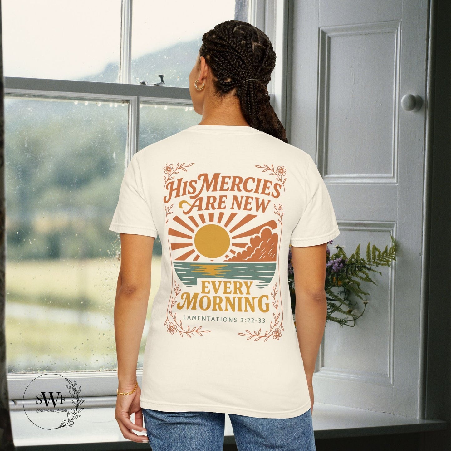 Back view of an ivory Christian women’s t-shirt with a retro sunrise design and the words “His Mercies Are New Every Morning – Lamentations 3:22–33.”