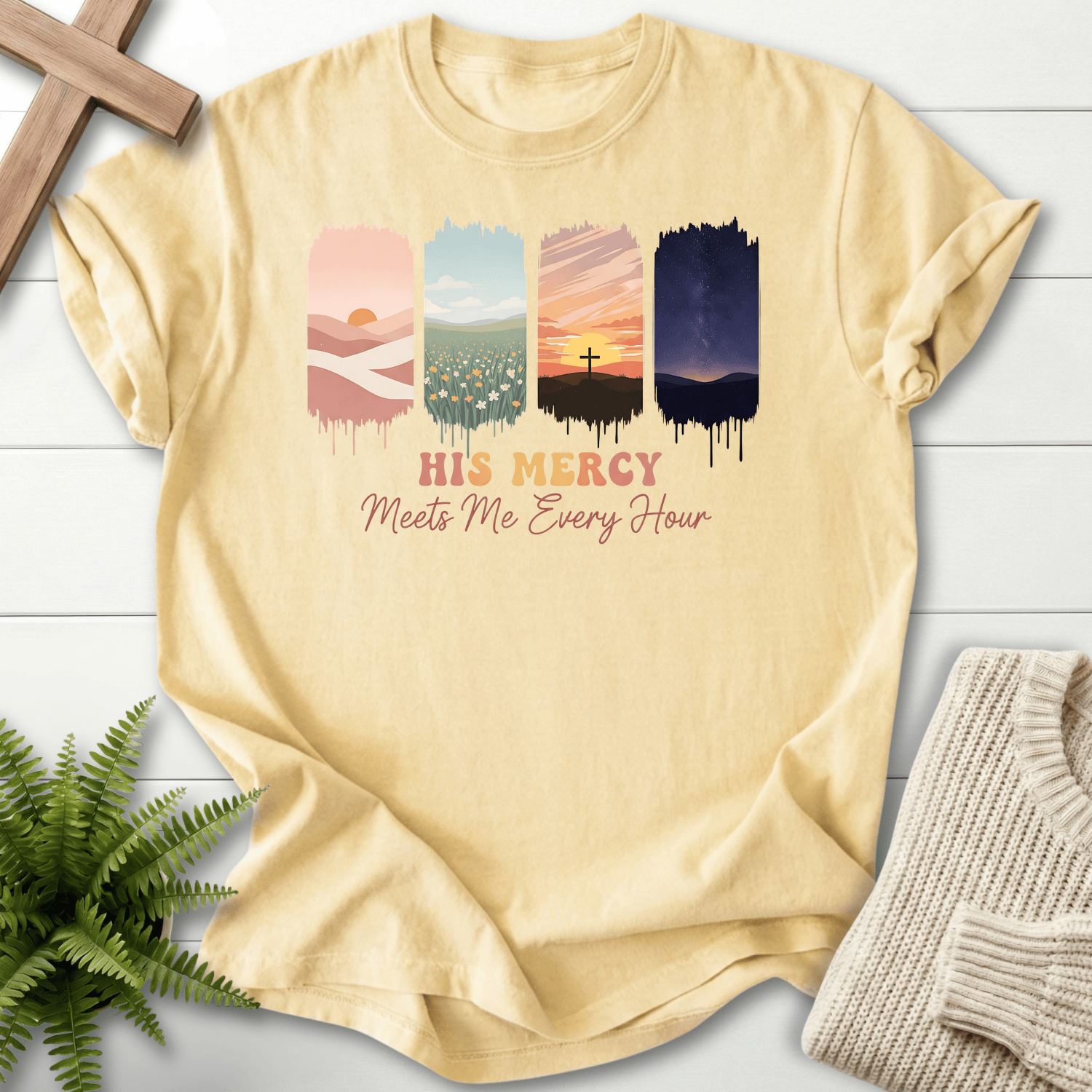Banana women's Christian t-shirt with a cross-at-sunset panel and colorful landscape art