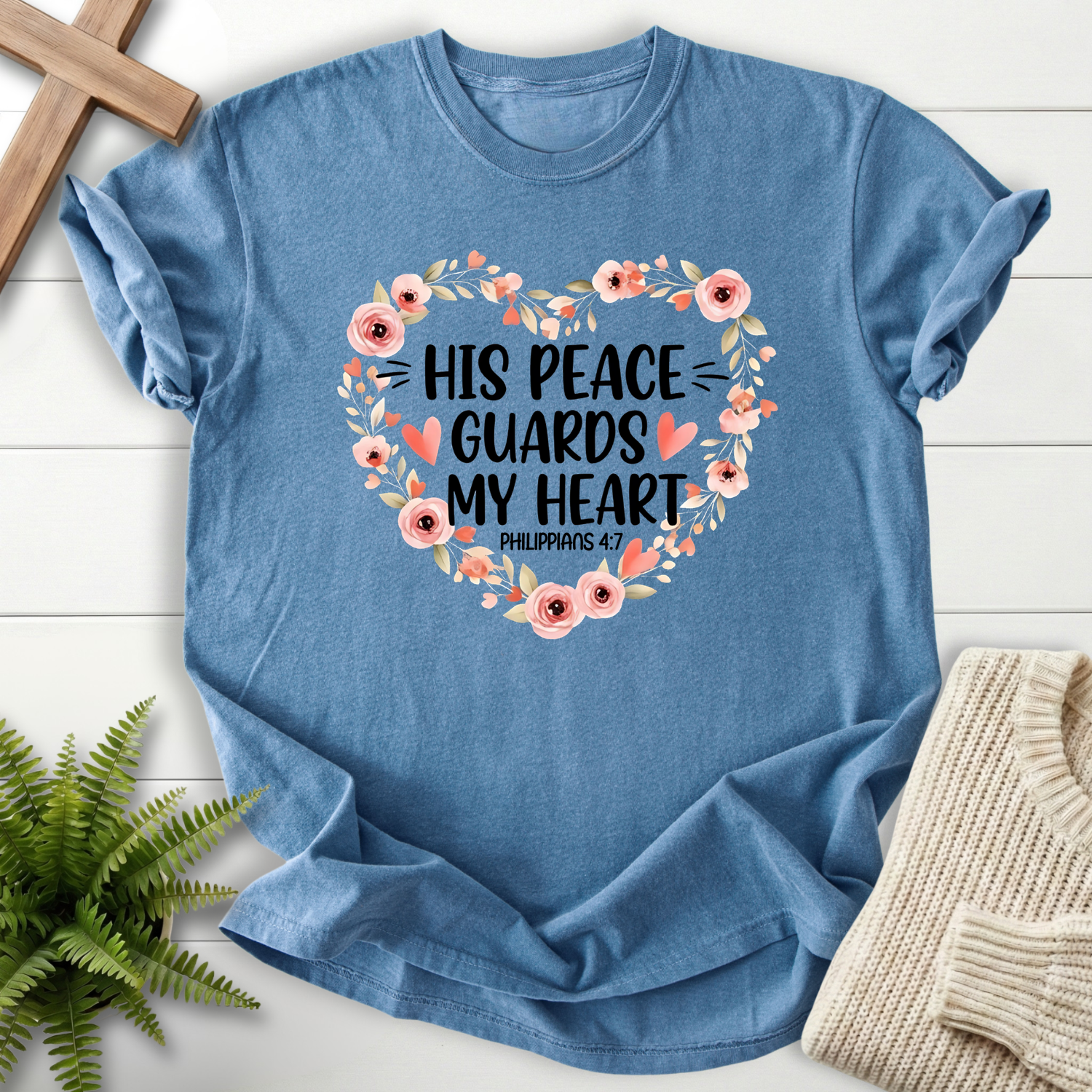 Blue Jean women's Christian t-shirt with "His Peace Guards My Heart" and a floral heart wreath, inspired by Philippians 4:7