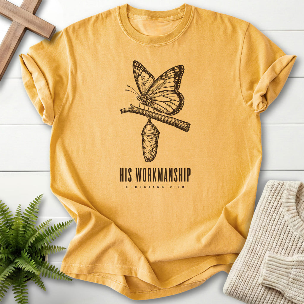 Flat lay of a Mustard Comfort Colors 1717 Christian t-shirt for women featuring butterfly artwork with "His Workmanship T-Shirt".