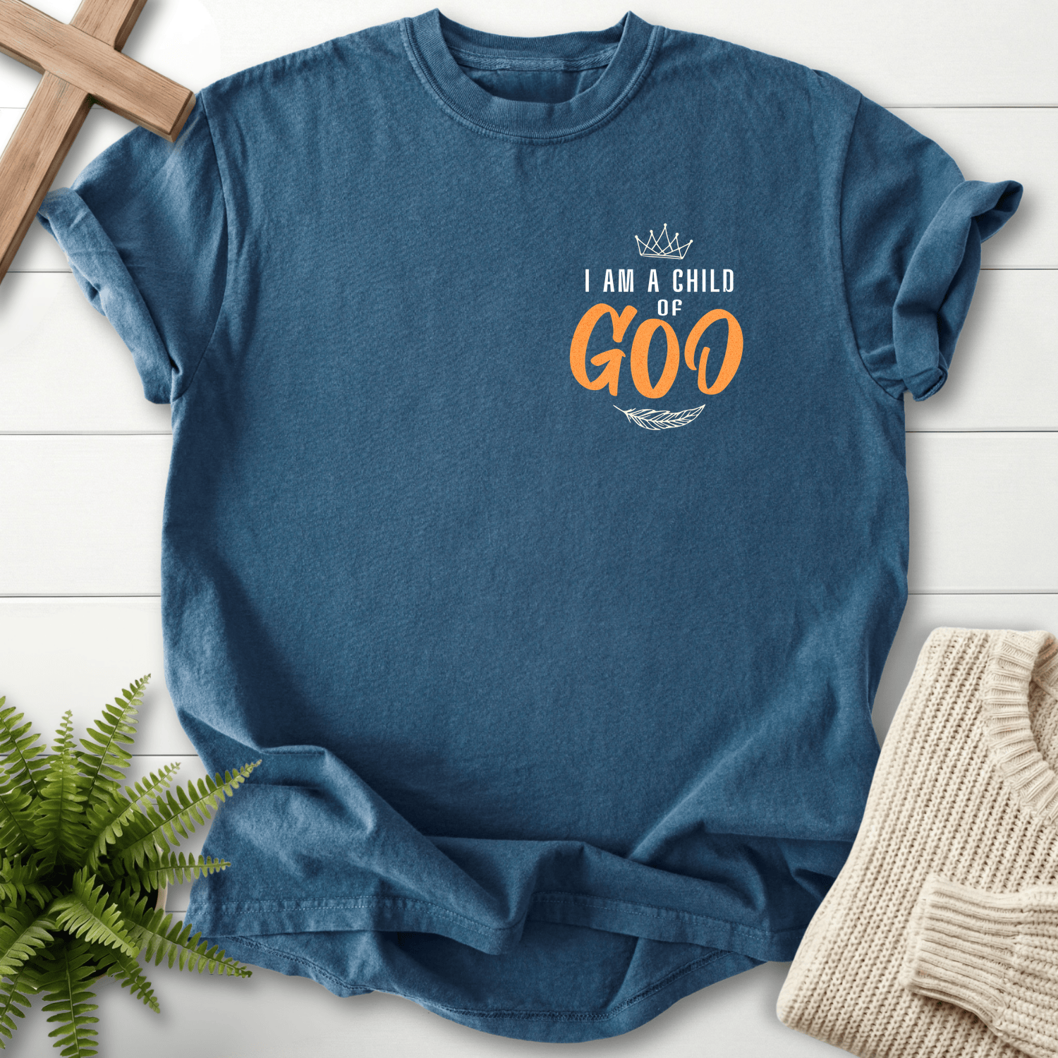 Midnight women's Christian t-shirt with a crown chest print and orange leaf accents on the left chest.
