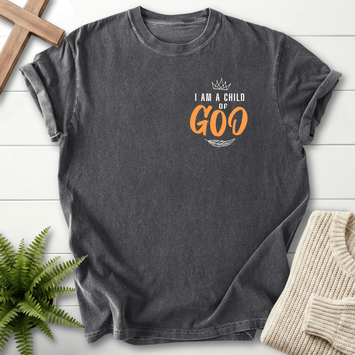 Pepper women's Christian t-shirt with a minimalist left-chest crown and pocket print reading "I Am a Child of God"