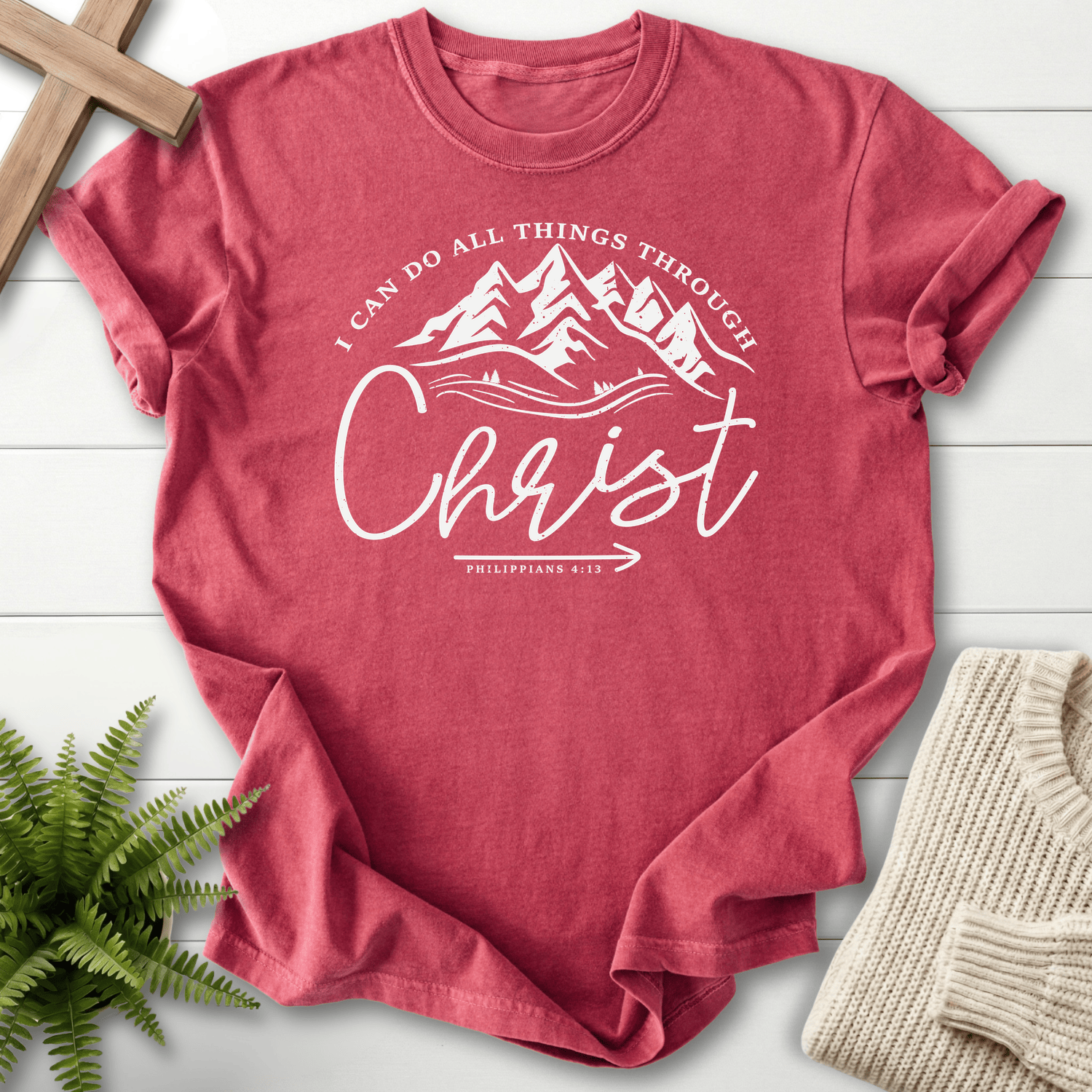Crimson women's Christian t-shirt with mountain and forest circle art and "I Can Do All Things Through Christ," inspired by Philippians 4:13