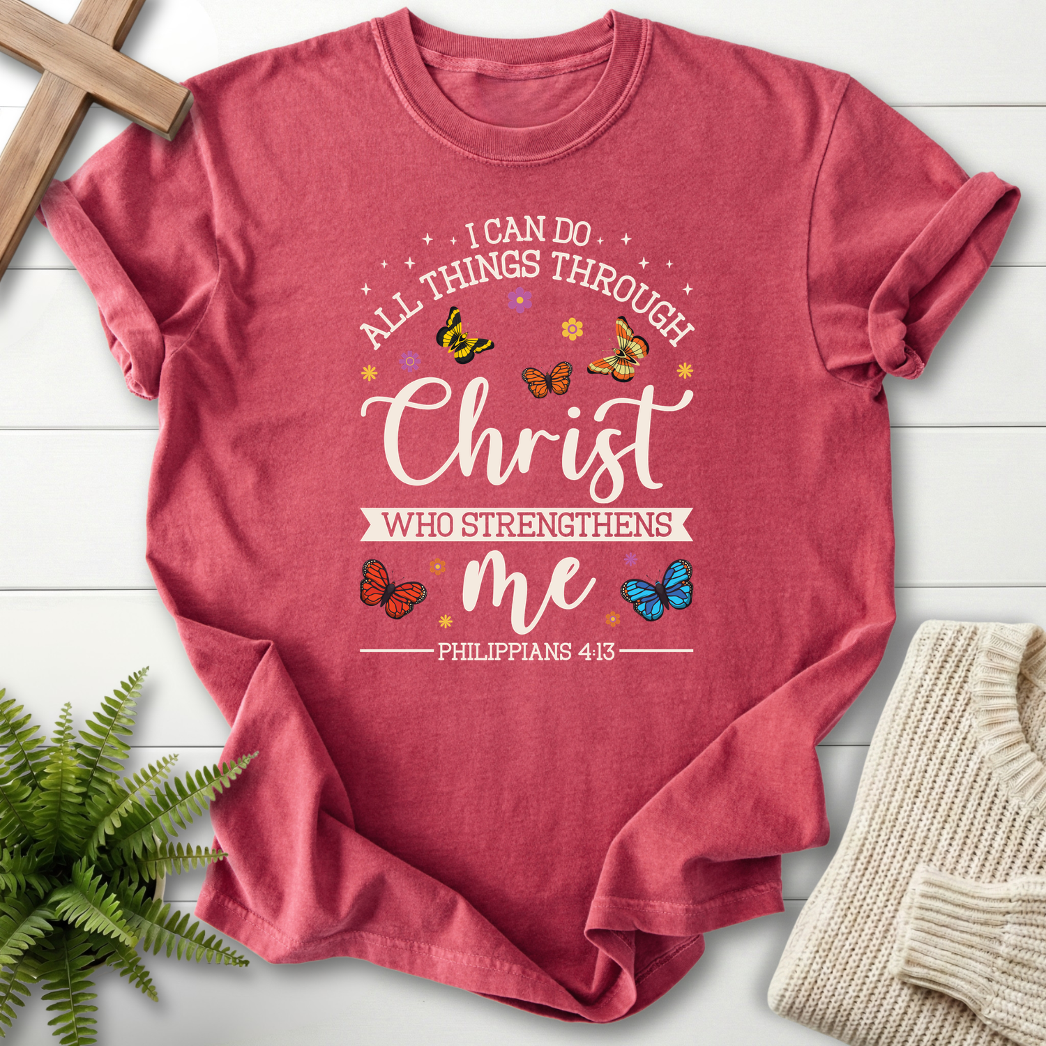 Crimson women's Christian t-shirt with colorful butterflies around "I Can Do All Things Through Christ," inspired by Philippians 4:13.