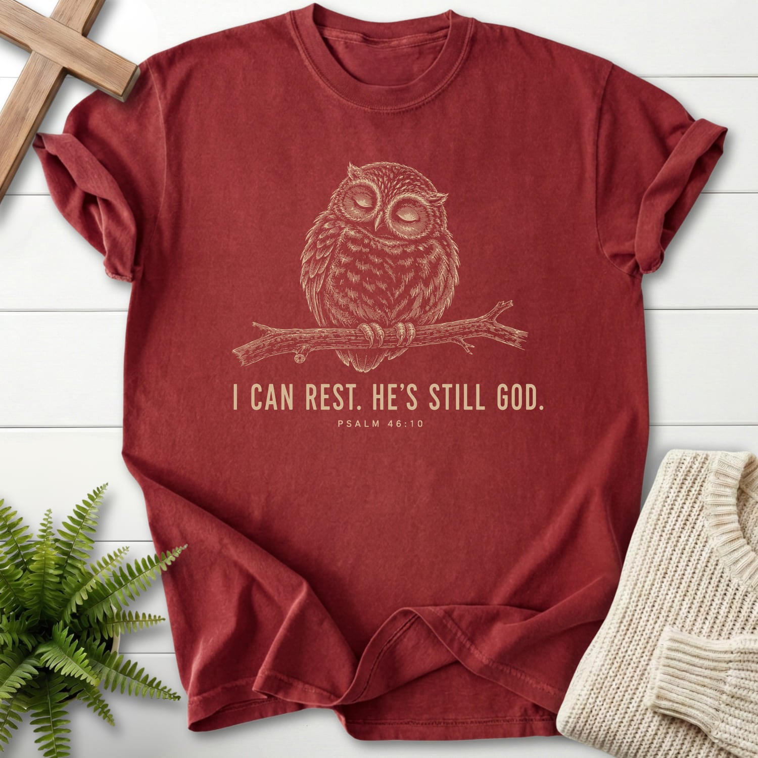 Flat lay of a Brick Christian shirt featuring "He is Still God T-Shirt" Psalm 46:10 For faith wear collections.