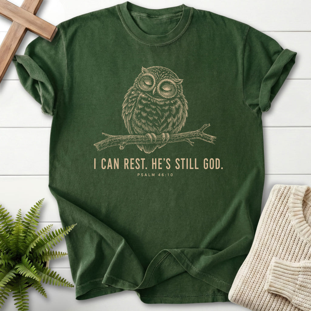 Flat lay of a Hemp Scripture shirt featuring "He is Still God T-Shirt" Psalm 46:10 For faith wear collections.