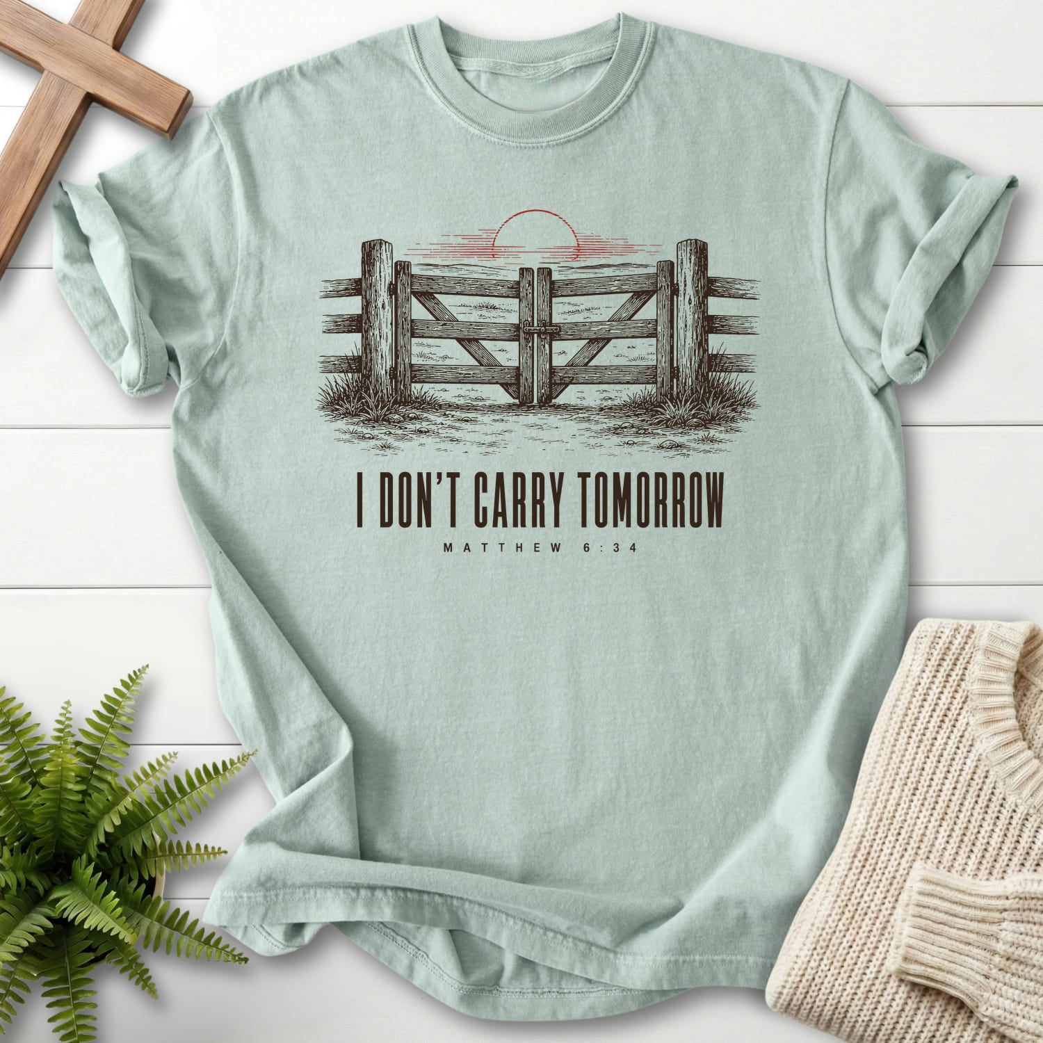 Flat lay of a Bay women's Christian tee featuring "I Don't Carry Tomorrow T-Shirt" Matthew 6:34.
