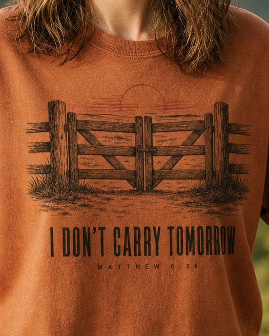 I Don't Carry - Yam women's Christian tee, lifestyle photo in nature trail - Wooden farm gate and fence at sunrise - Matthew 6:34 - She Wears Faith