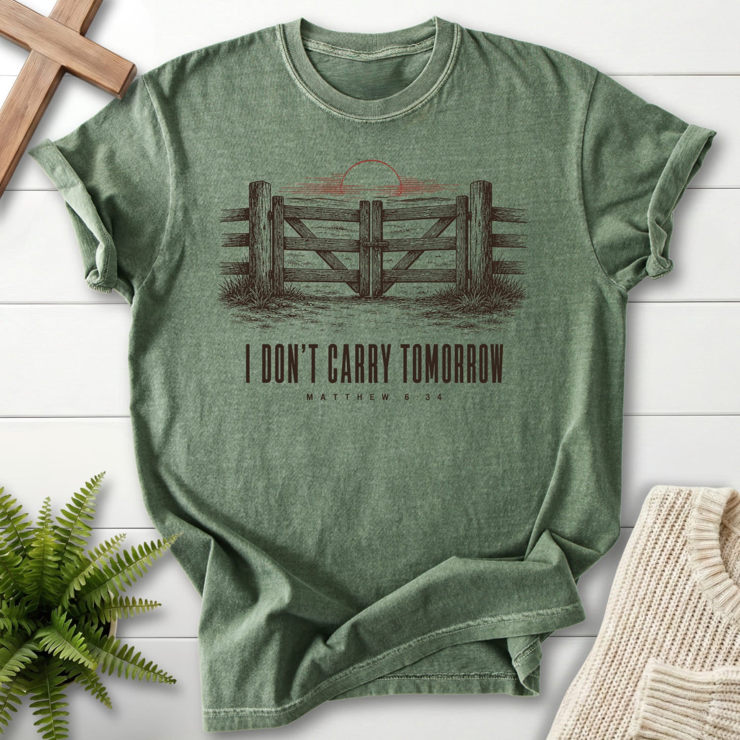 Flatlay of a Moss faith-based tee with "I Don't Carry Tomorrow T-Shirt" Matthew 6:34 For faith wear collections.