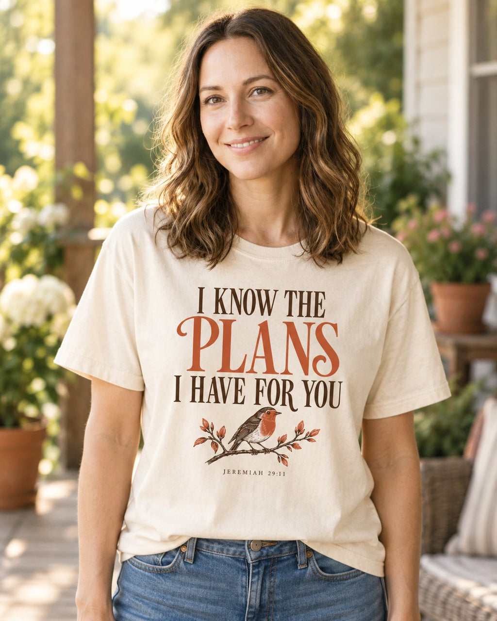 I Know the Plans Bird, Ivory women's Christian tee, lifestyle photo in sunny porch, I KNOW THE PLANS I HAVE FOR YOU lettering with a robin on a branch, She Wears Faith