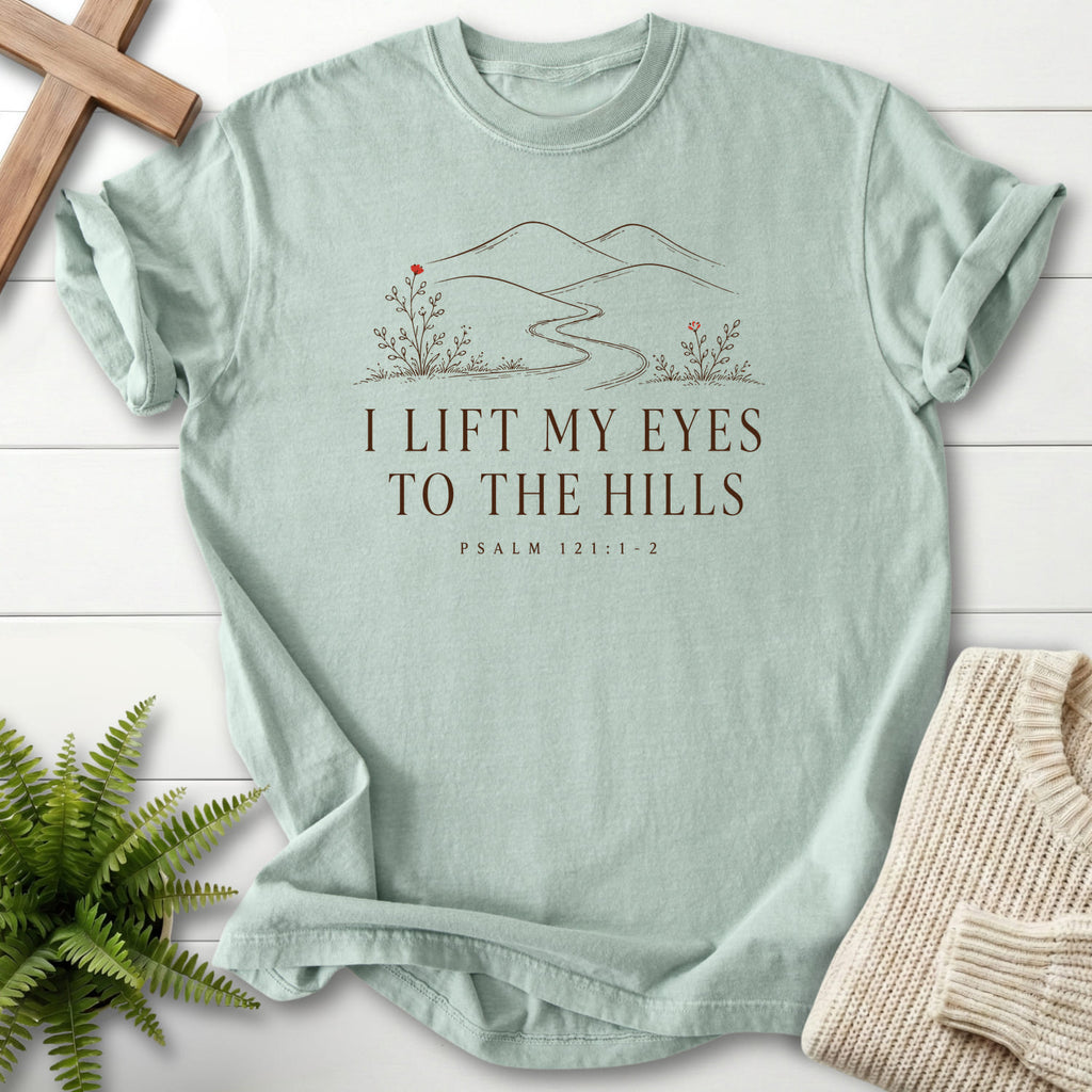 Flat lay of a Bay Christian graphic tee featuring floral line art with "I Lift My Eyes to the Hills T-Shirt" Psalm 121:1-2.