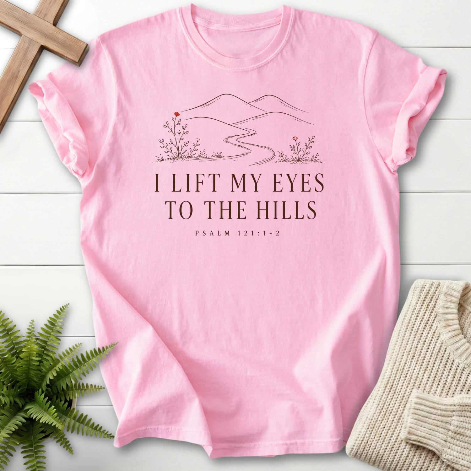 Flatlay of a Blossom Comfort Colors 1717 women's Christian tee with floral line art with "I Lift My Eyes to the Hills T-Shirt" Psalm 121:1-2.