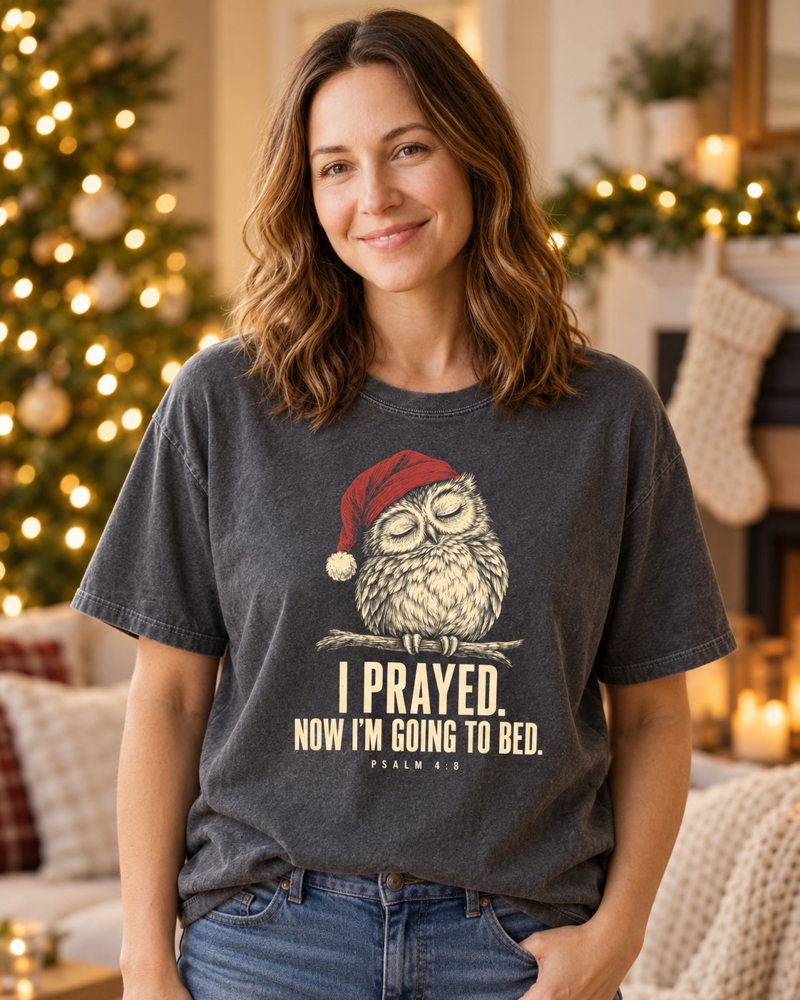 I Prayed Now I'm Going to Bed, Pepper women's Christian tee, lifestyle photo in living room by the Christmas tree, sleeping owl in a Santa hat with I PRAYED lettering, She Wears Faith
