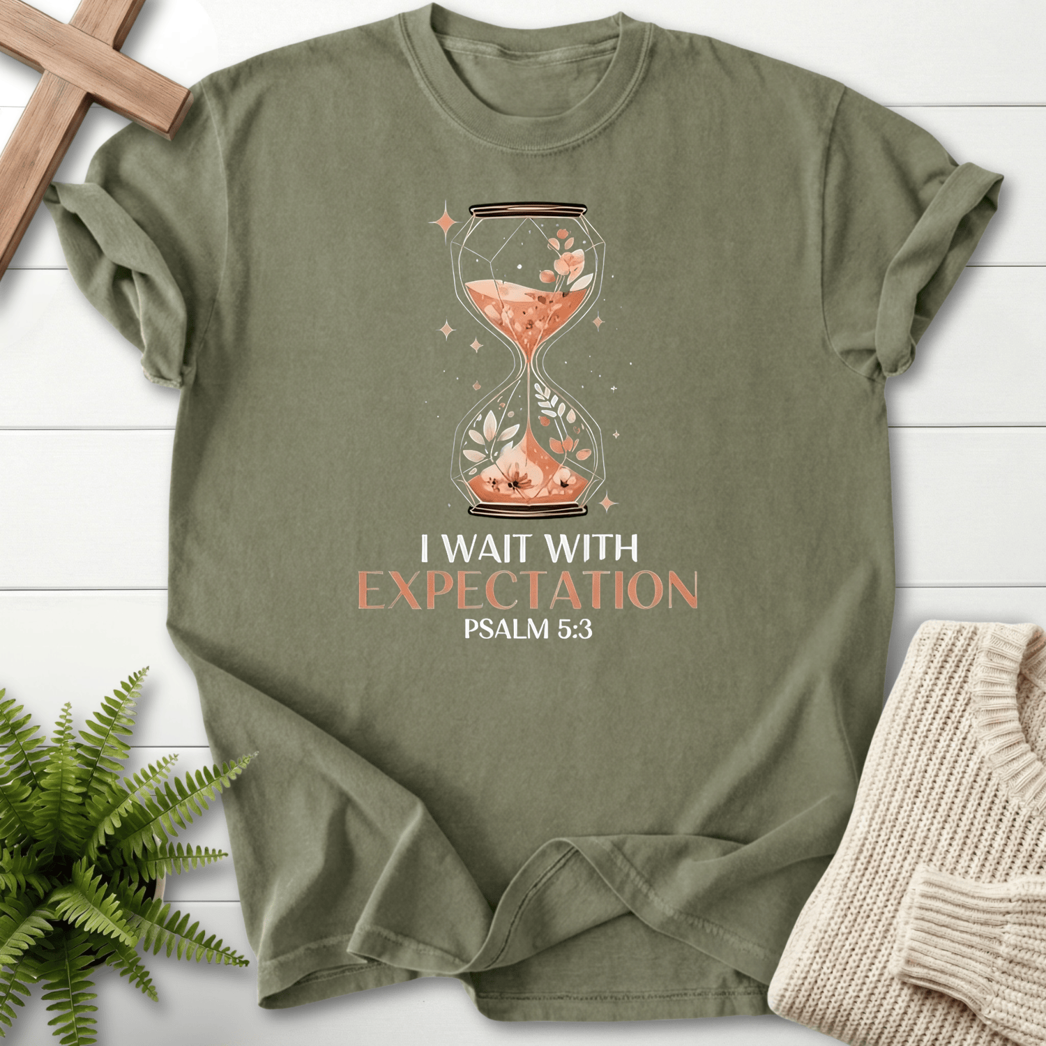 Sage women's Christian t-shirt with an ornate hourglass, wildflowers, and sparkles, inspired by Psalm 5:3.