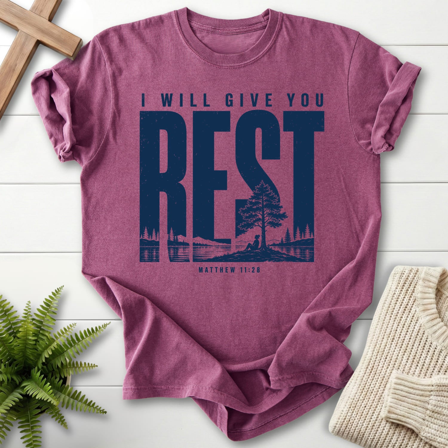 Flat lay of a Berry Christian shirt featuring "I Will Give You Rest T-Shirt" Matthew 11:28.