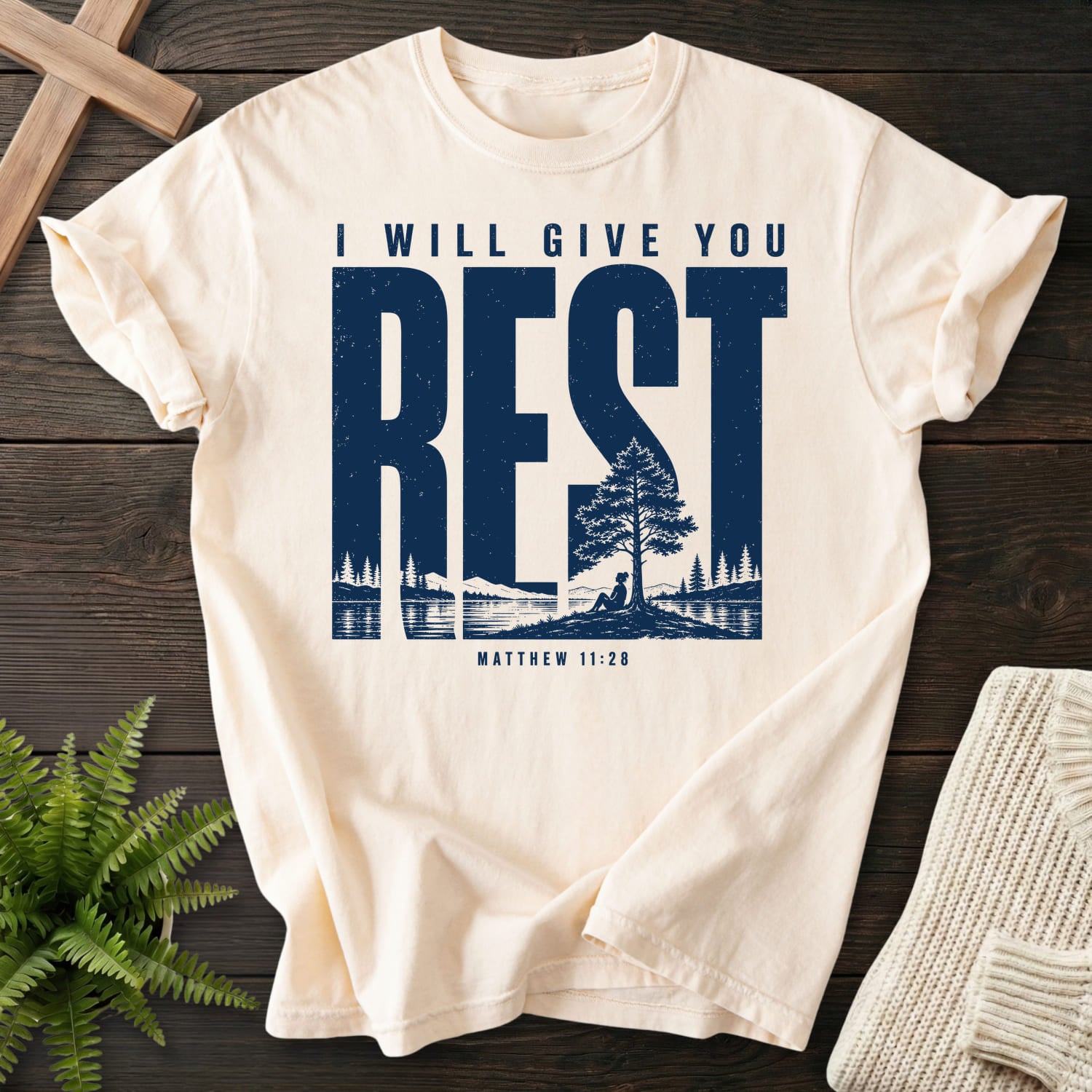 Flatlay of an Ivory Bible verse tee with "I Will Give You Rest T-Shirt" Matthew 11:28.