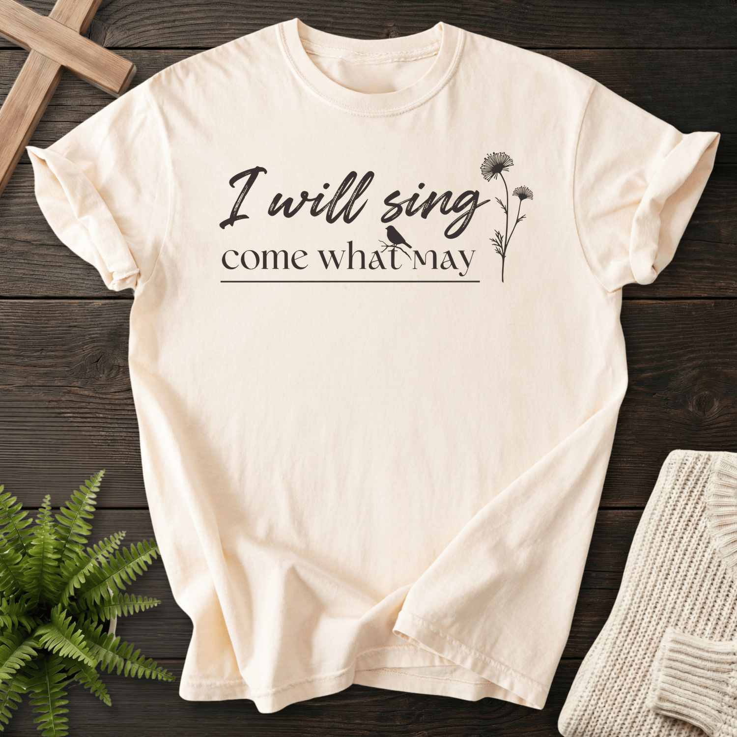 Ivory women's Christian t-shirt with "I will sing come what may" hand-lettered script and a wildflower bird accent