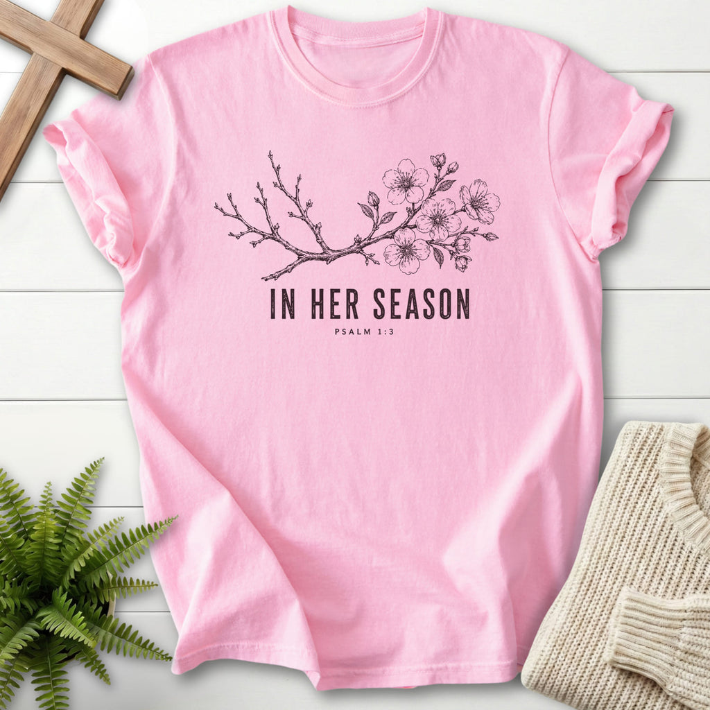 Flatlay of a Blossom Comfort Colors 1717 faith-inspired shirt with flowering branch artwork with "In Her Season T-Shirt" Psalm 1:3.