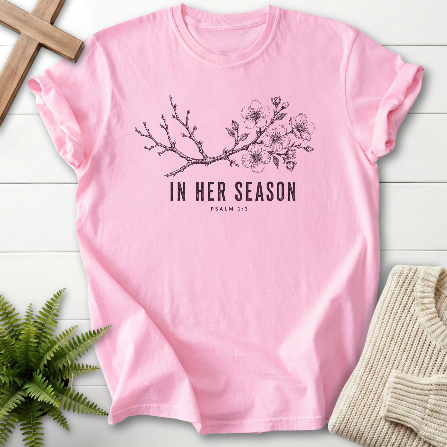 Flatlay of a Blossom Comfort Colors 1717 faith-inspired shirt with flowering branch artwork with "In Her Season T-Shirt" Psalm 1:3.