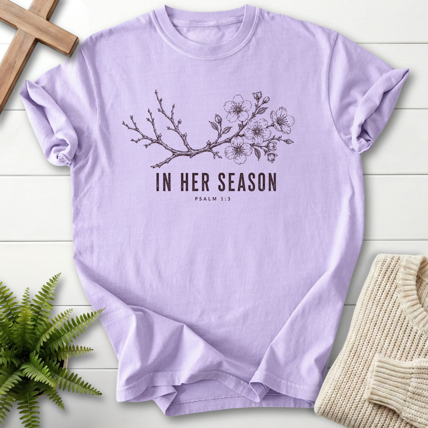 Flat lay of an Orchid Bible verse tee featuring flowering branch artwork with "In Her Season T-Shirt" Psalm 1:3.